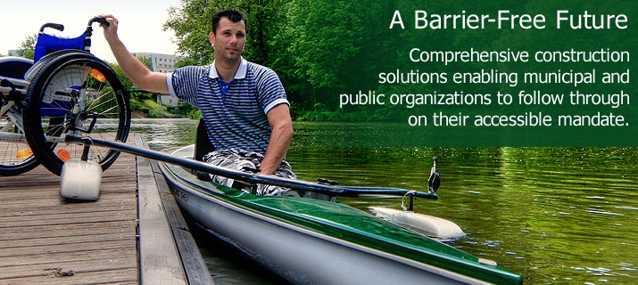A man in a canoe beside a pier with a wheelchair.