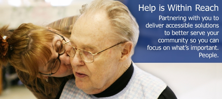 A lady kissing an elderly man in glasses.