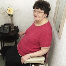 Women sitting in stair lift chair.