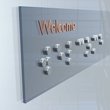 Welcome sign with braille.